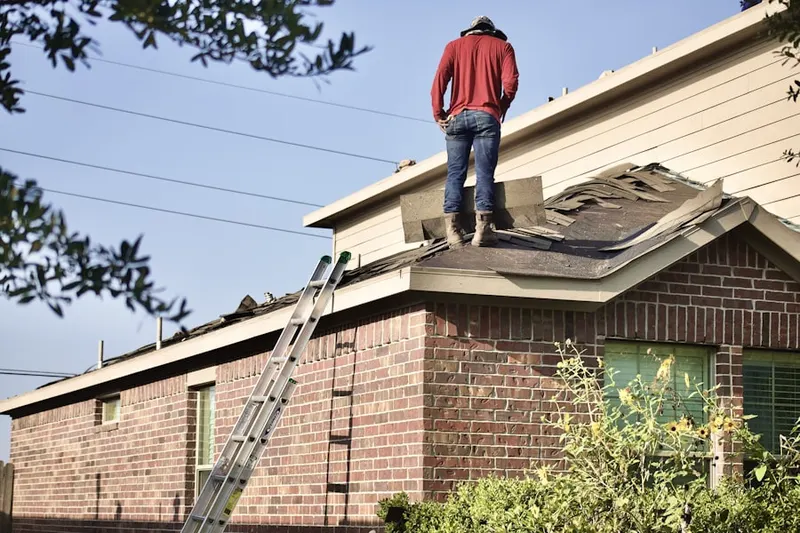 Professional roofer working on a residential roof in Plattsville